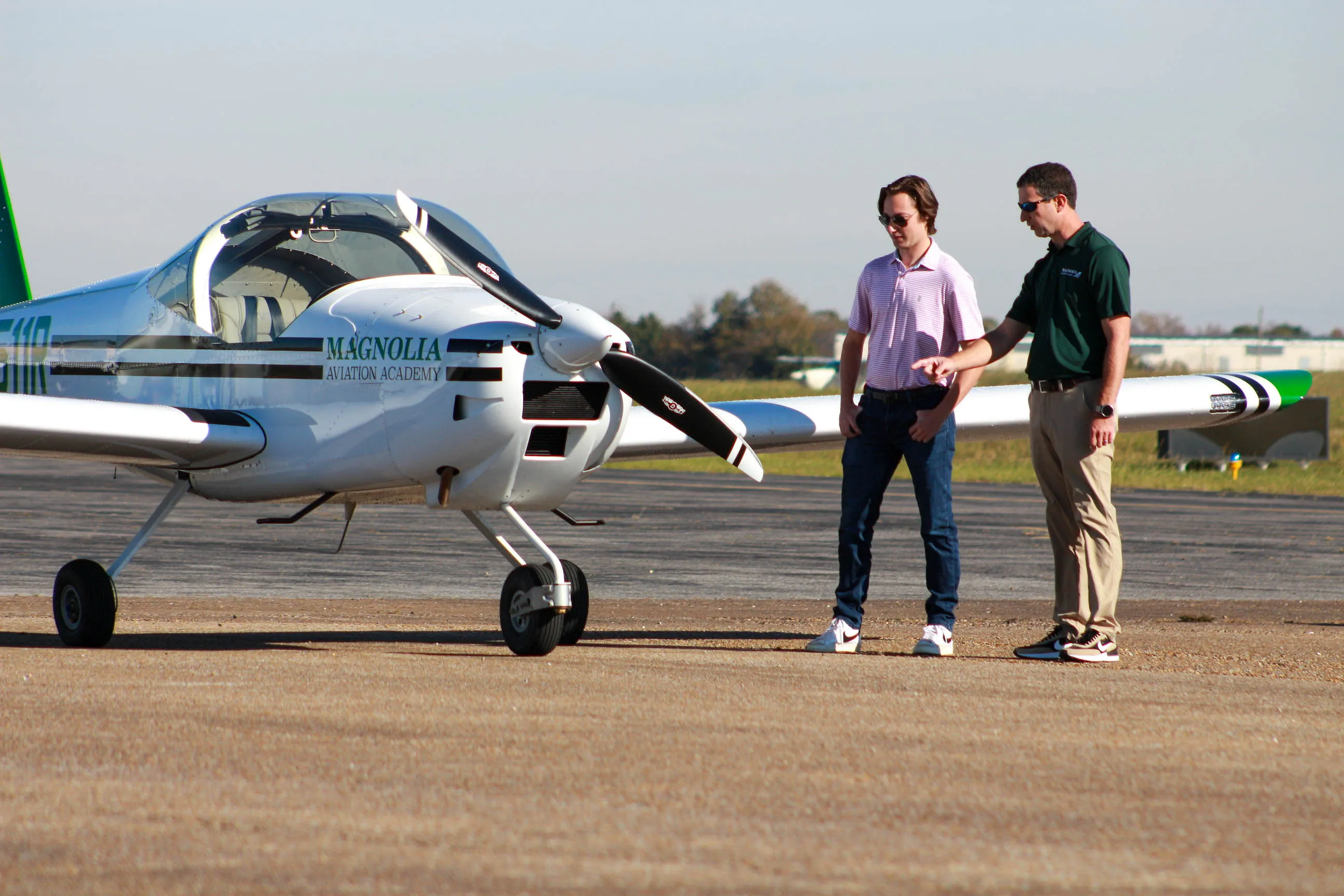 Magnolia Aviation Academy instructor and student beside a training aircraft