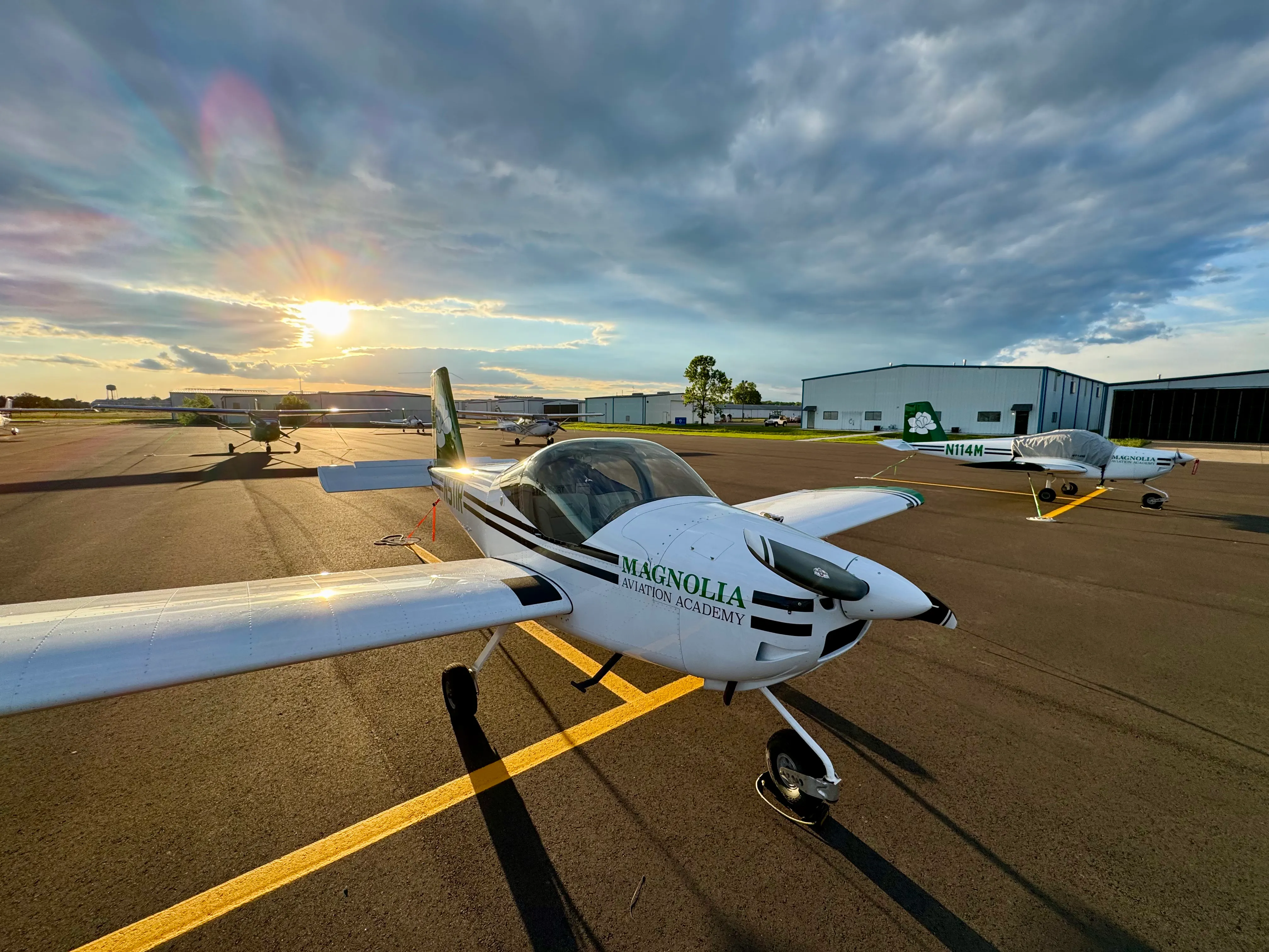 Magnolia Aviation Academy instructor guiding a student pilot on the flight line
